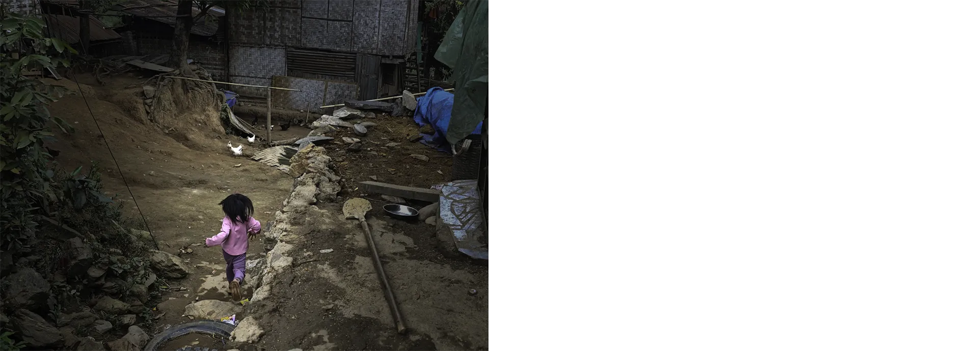 little girl laos running through village