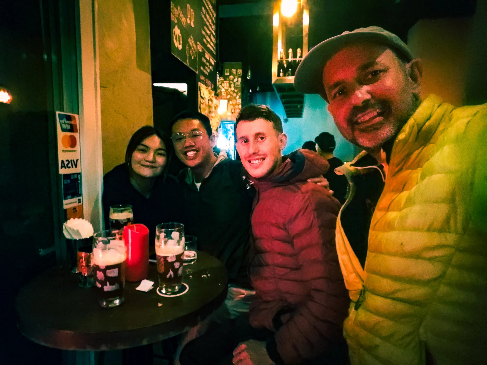 Group selfie with friends over beers at a Belgian bar in Hong Kong on a night out