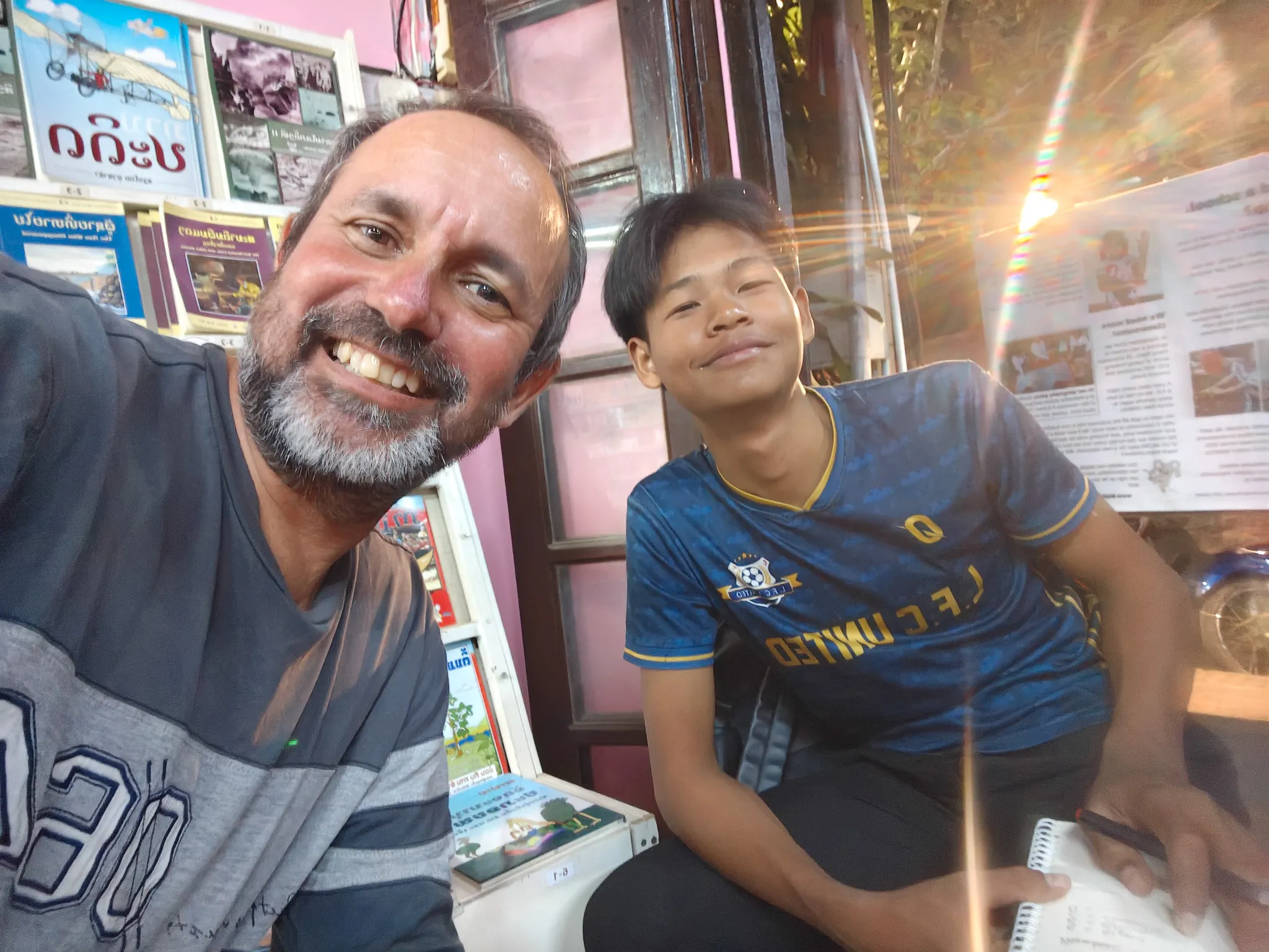 Selfie with Down, a 17-year-old Khmu student, at the Big Brother Mouse library in Luang Prabang surrounded by Lao language books