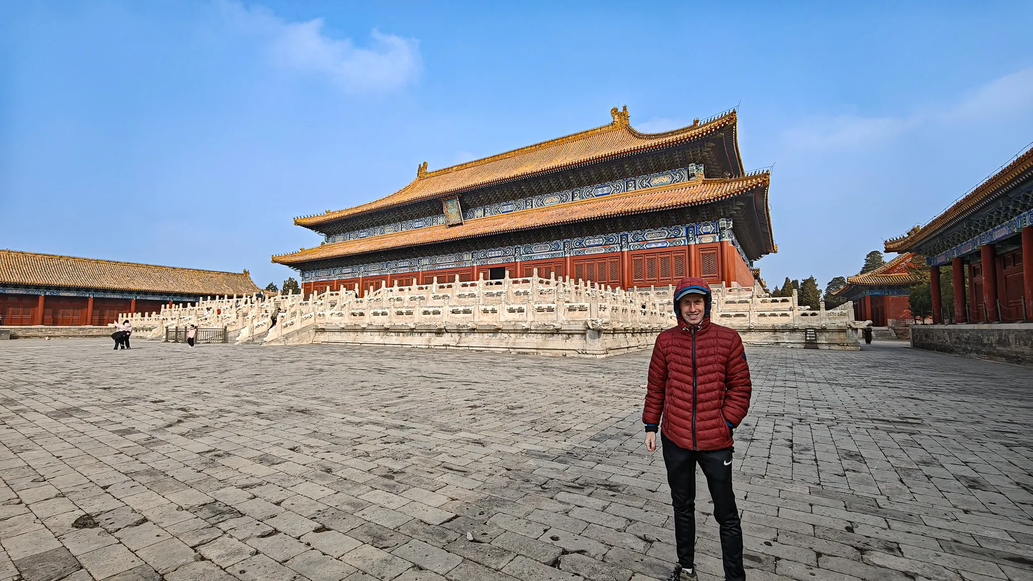 Standing in the vast stone courtyard in front of a grand hall inside the Forbidden City in Beijing on a crisp winter day