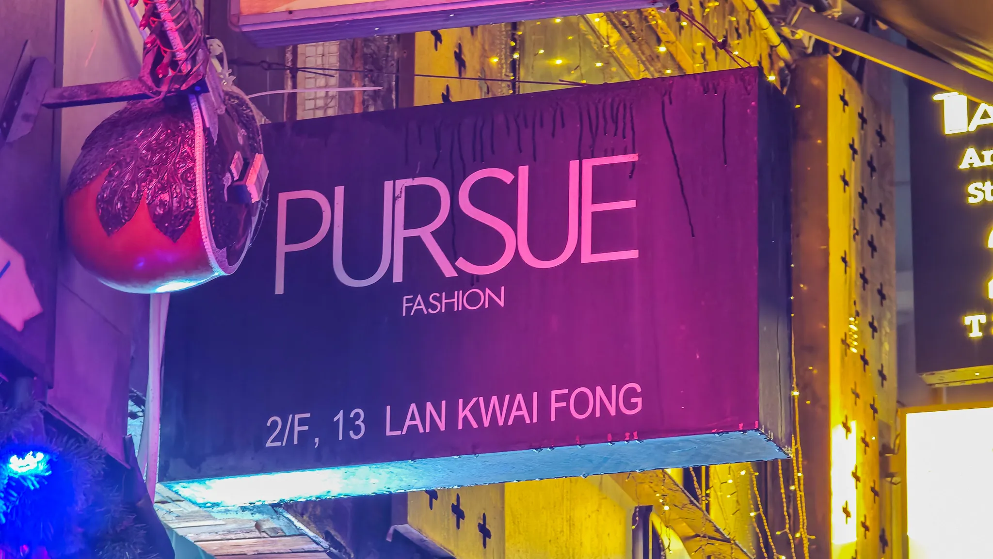 Neon-lit Pursue Fashion sign at Lan Kwai Fong in Hong Kong nightlife district