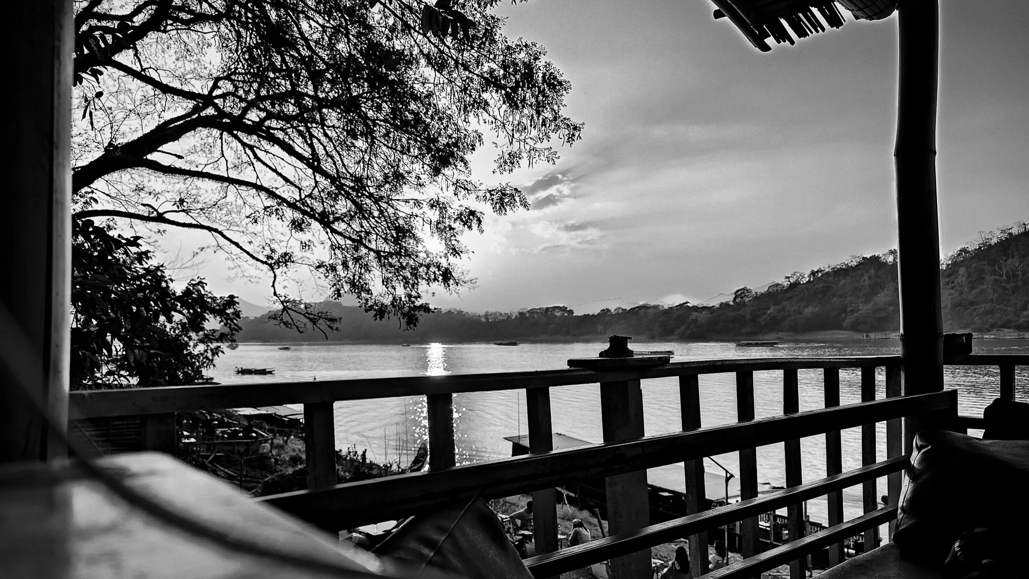 Black and white view of the Mekong River at sunset from a rooftop terrace in Luang Prabang
