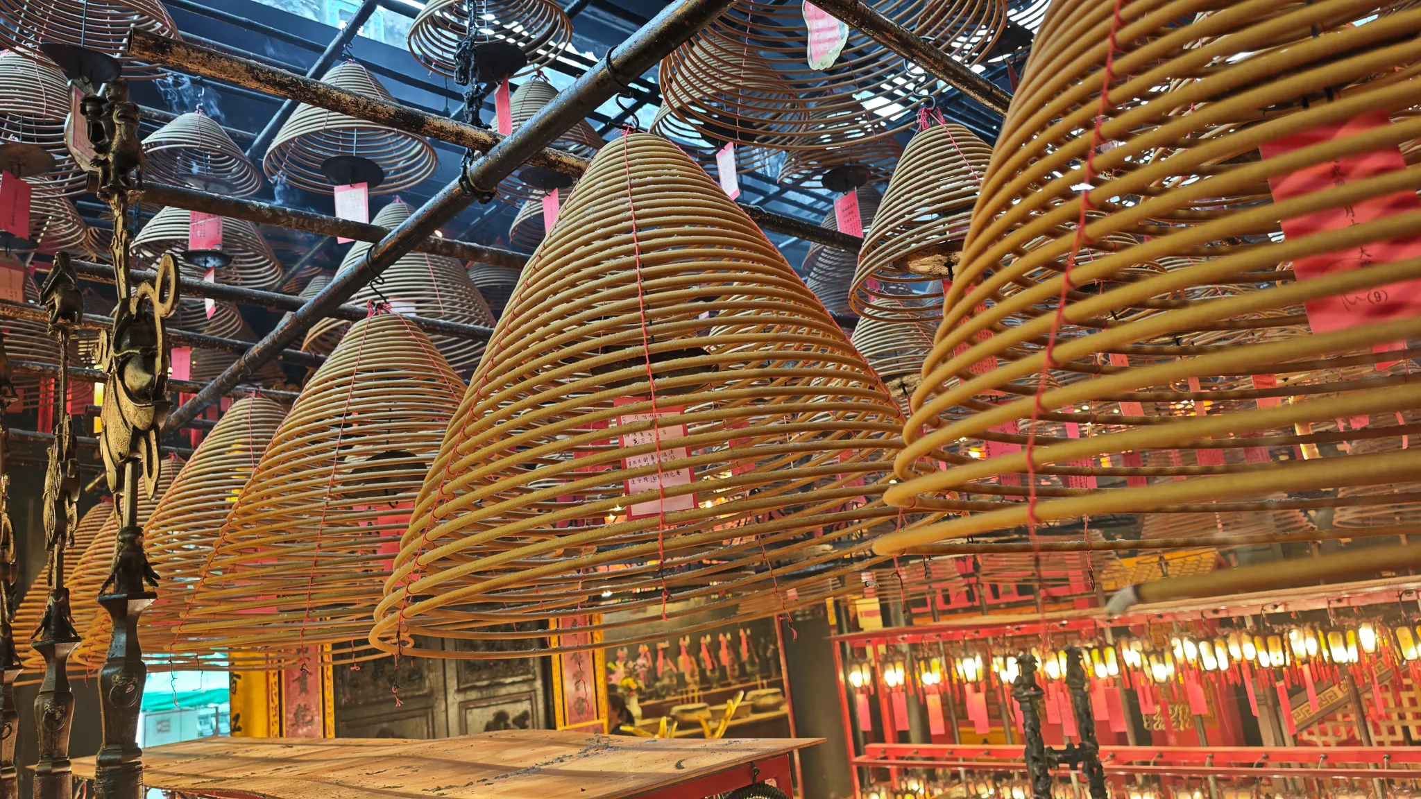 Giant spiral incense coils hanging from the ceiling inside Man Mo Temple in Hong Kong
