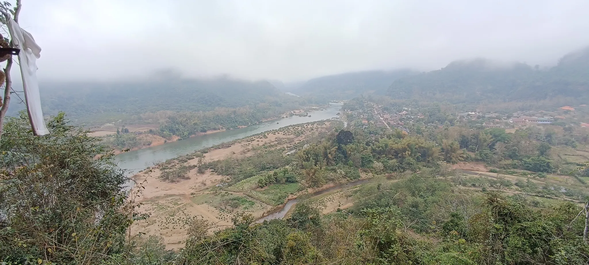 Misty view looking down the Nam Ou valley from the Muang Ngoi viewpoint trail