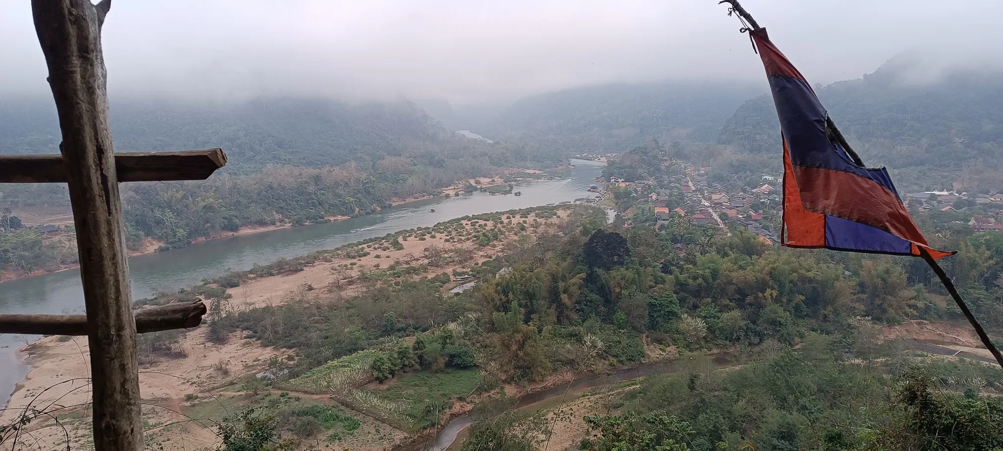 Misty morning view from the viewpoint above Muang Ngoi showing the Nam Ou river winding through karst mountains