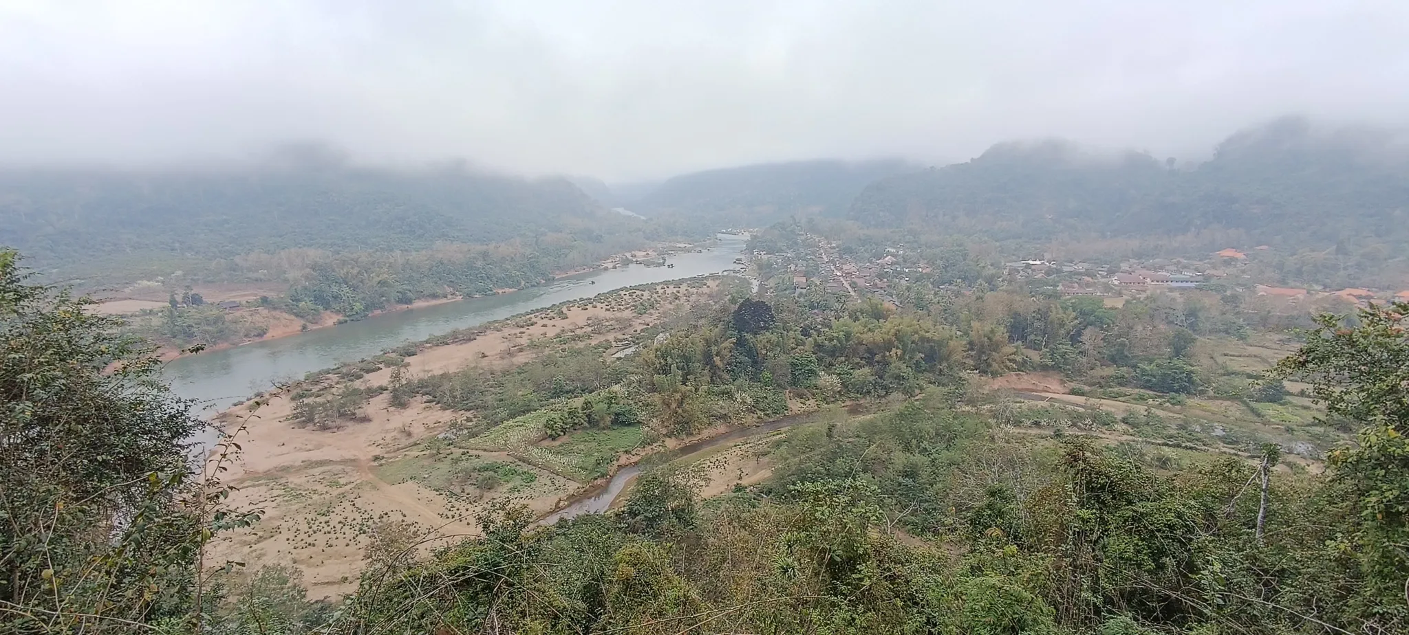 Overcast panorama of the Nam Ou river and surrounding hills from the Muang Ngoi viewpoint