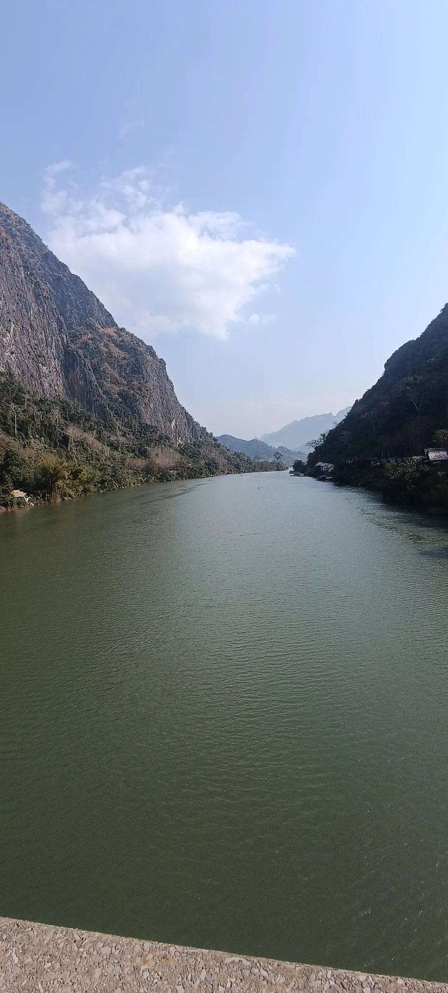Portrait view of the Nam Ou gorge with steep karst cliffs on both sides near Nong Khiaw