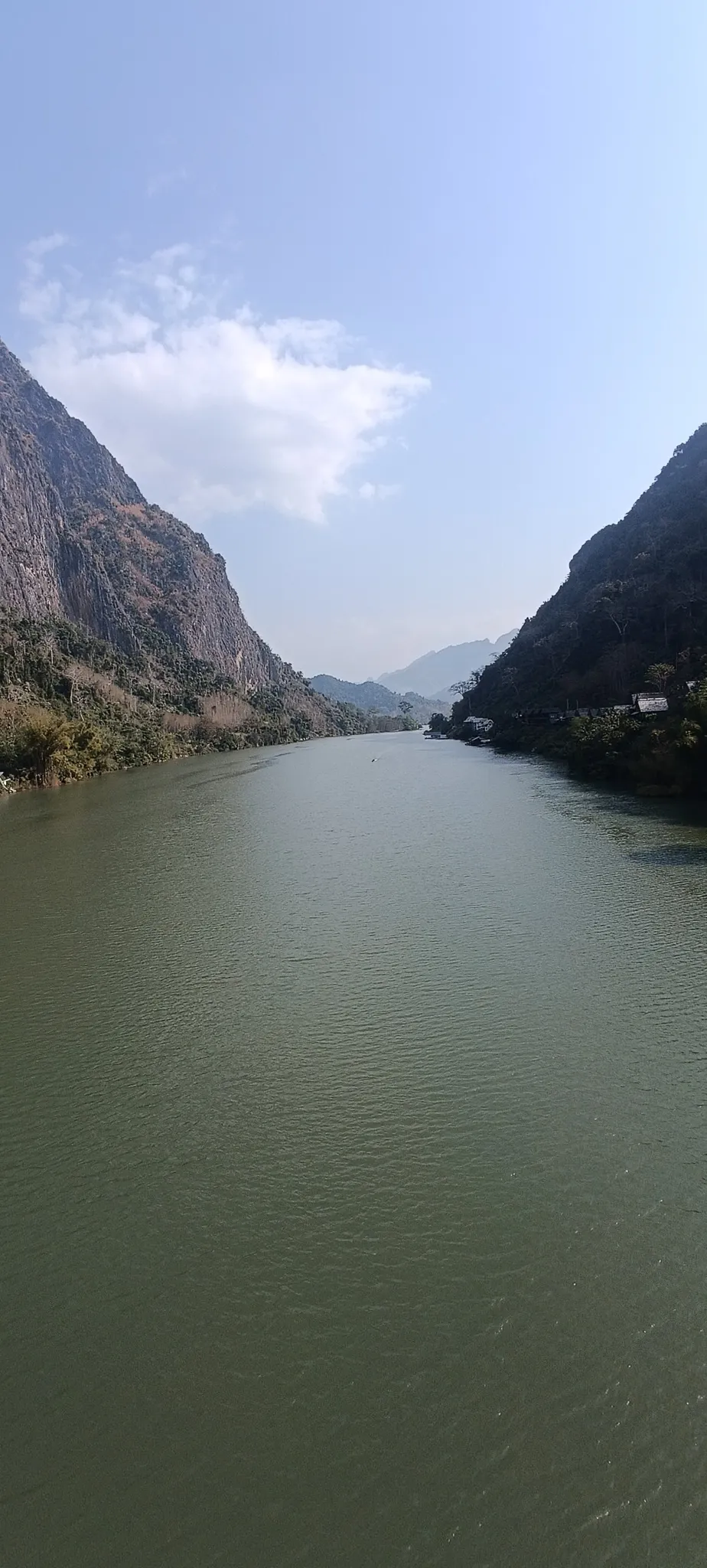 Portrait view looking down the Nam Ou river valley with karst peaks fading into the haze
