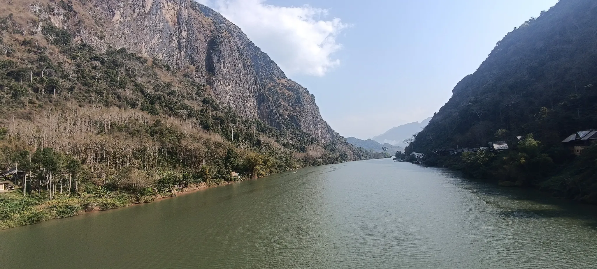 Limestone cliffs and the Nam Ou river looking upstream from the Nong Khiaw bridge on a clear day