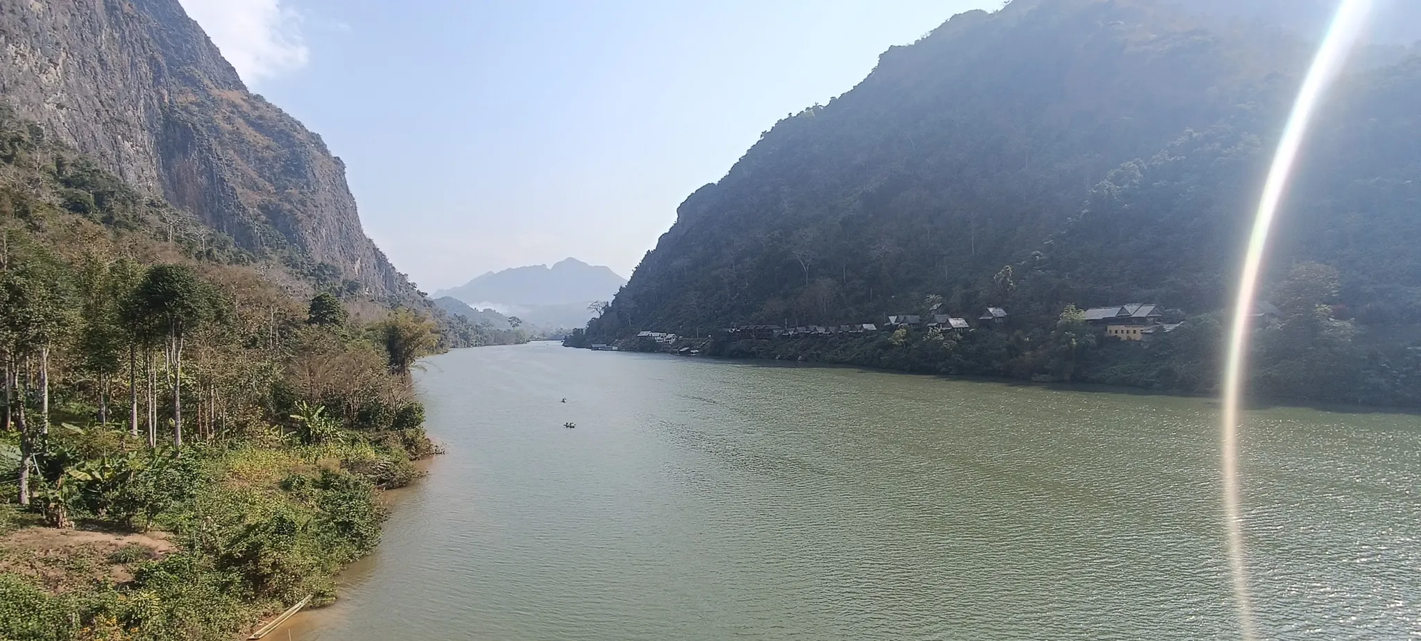 View from Nong Khiaw bridge looking upstream along the Nam Ou river flanked by towering karst cliffs