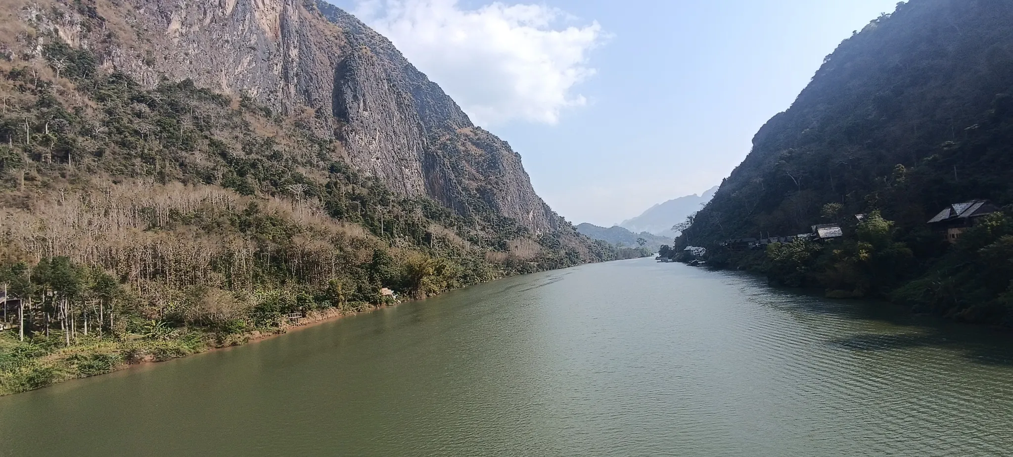 Panoramic view from the bridge at Nong Khiaw with karst mountains and the Nam Ou river stretching into the distance