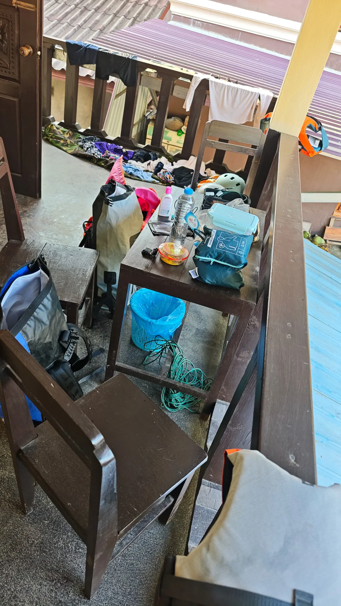Packrafting gear and clothes drying on a guesthouse balcony in Muang Ngoi before the kayak to Nong Khiaw