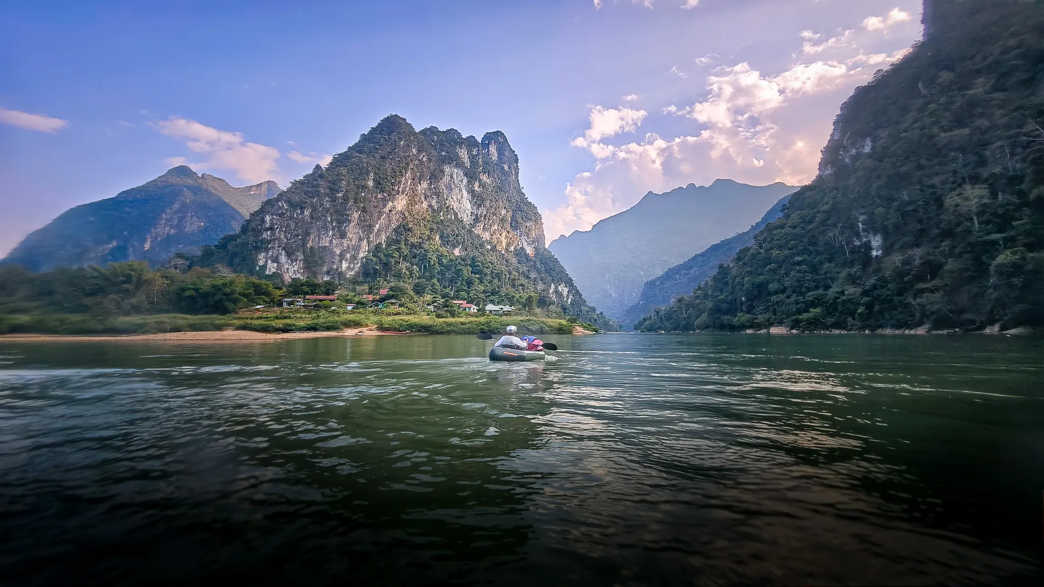 Packraft on the wide Nam Ou beneath karst mountains near Muang Ngoi