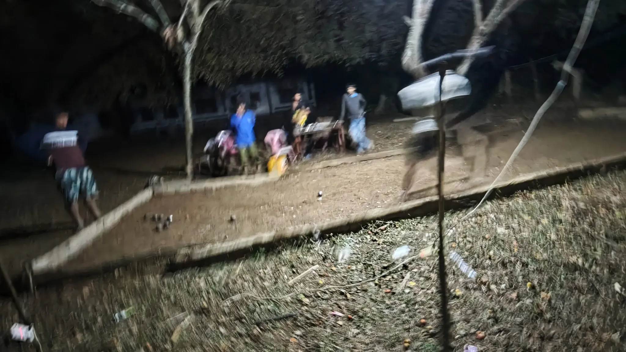 Villagers playing petanque at night on a floodlit dirt court near the school in Ban Haddean village on the Nam Ou