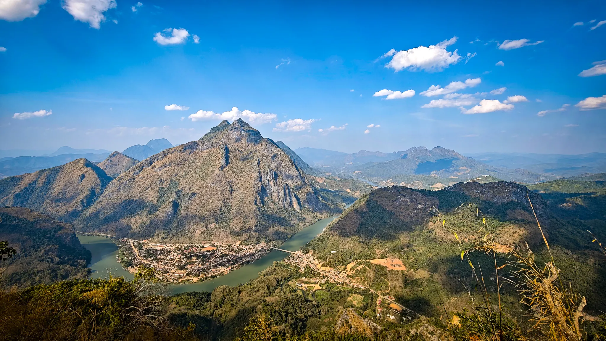 Wide panorama from Pha Kew Lom viewpoint overlooking the entire Nam Ou valley and Nong Khiaw below