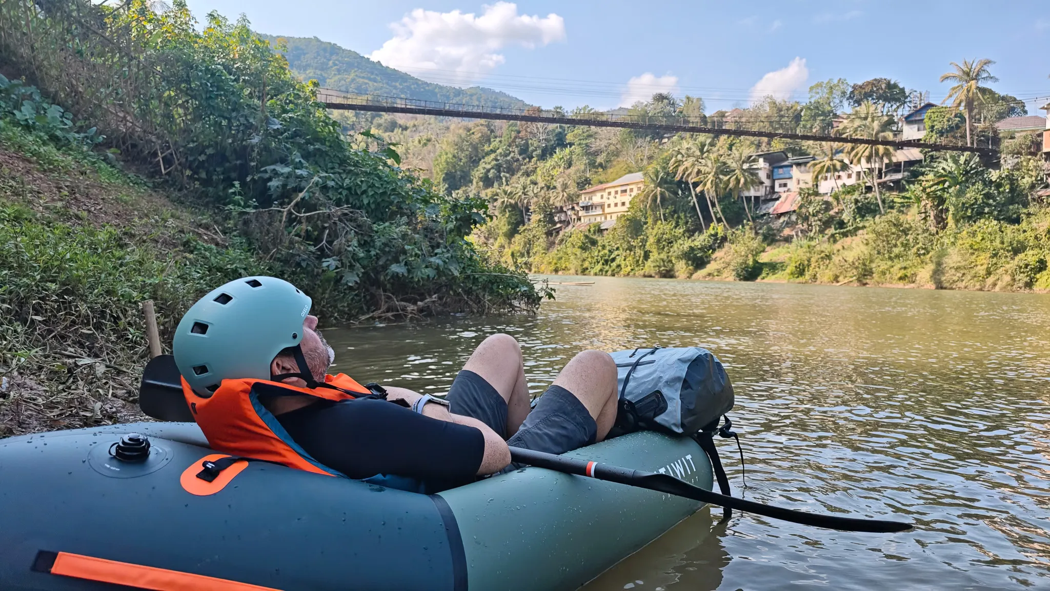 Two Itiwit packrafts rafted together on the Nam Ou river near the Muang Khua suspension bridge with blue dry bag visible