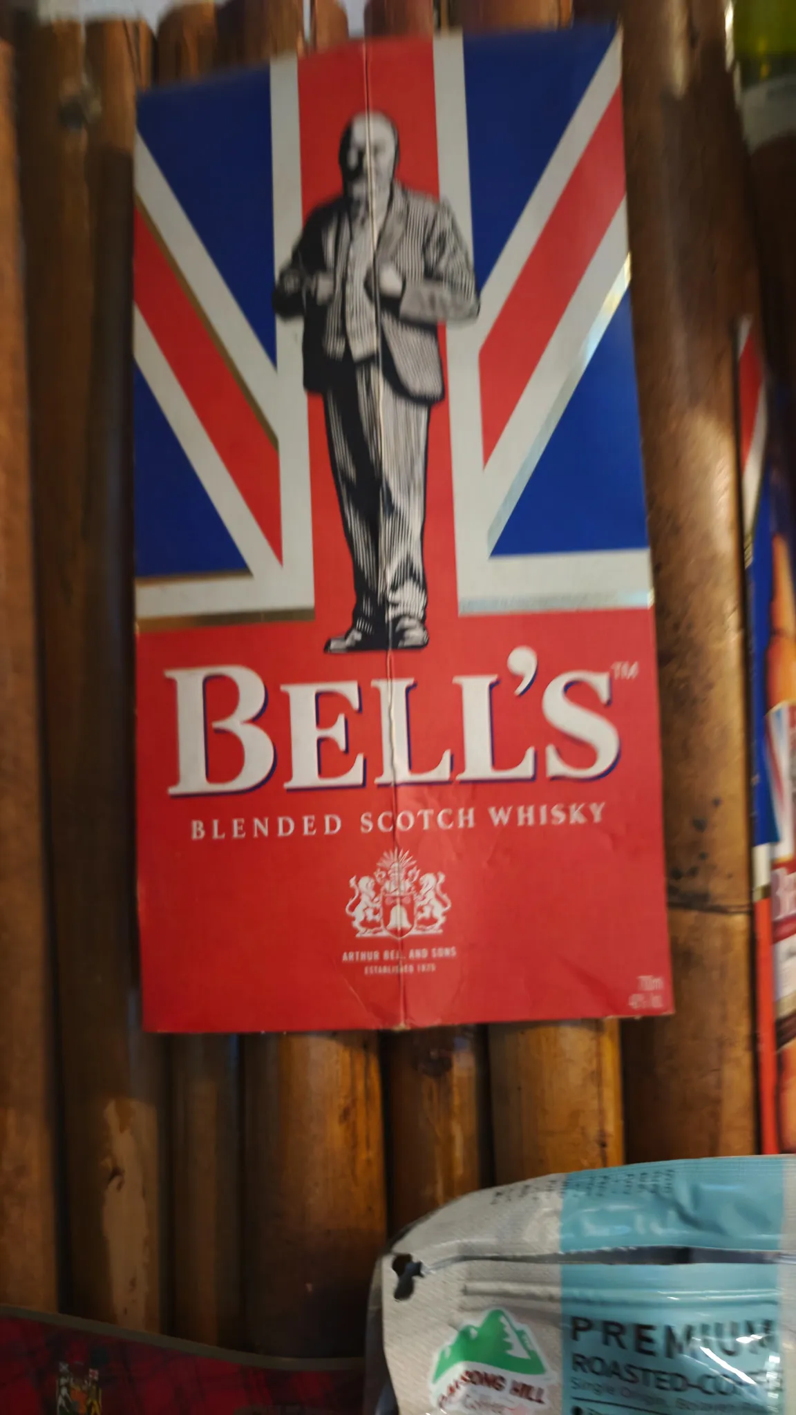 Bells Blended Scotch Whisky vintage poster with Union Jack at a British-run bar in Vang Vieng