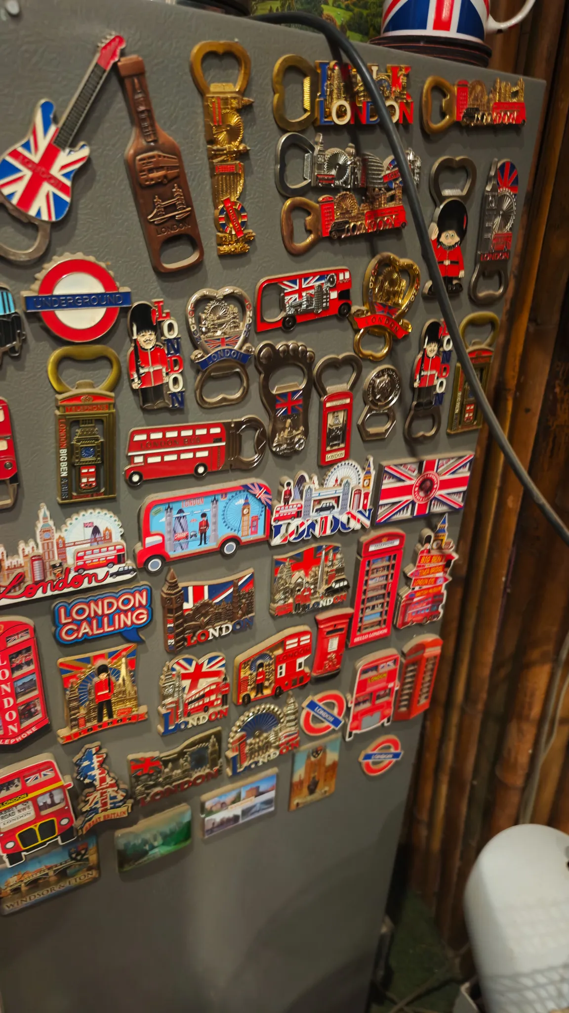 Fridge covered in London-themed magnets including red buses, phone boxes and Union Jacks at a British-run bar in Vang Vieng
