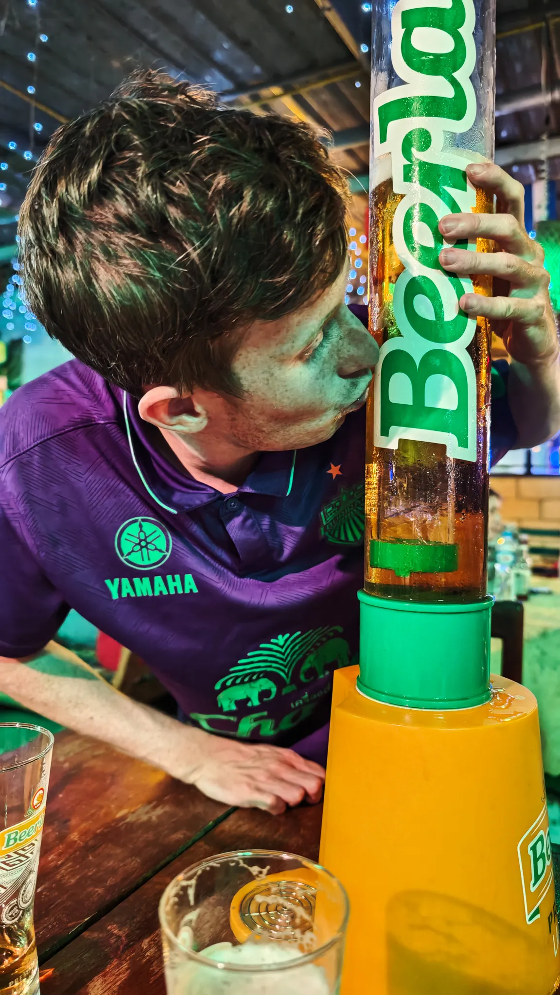 Close-up of a Beer Lao branded beer tower being poured at a bar during the Vang Vieng pub crawl