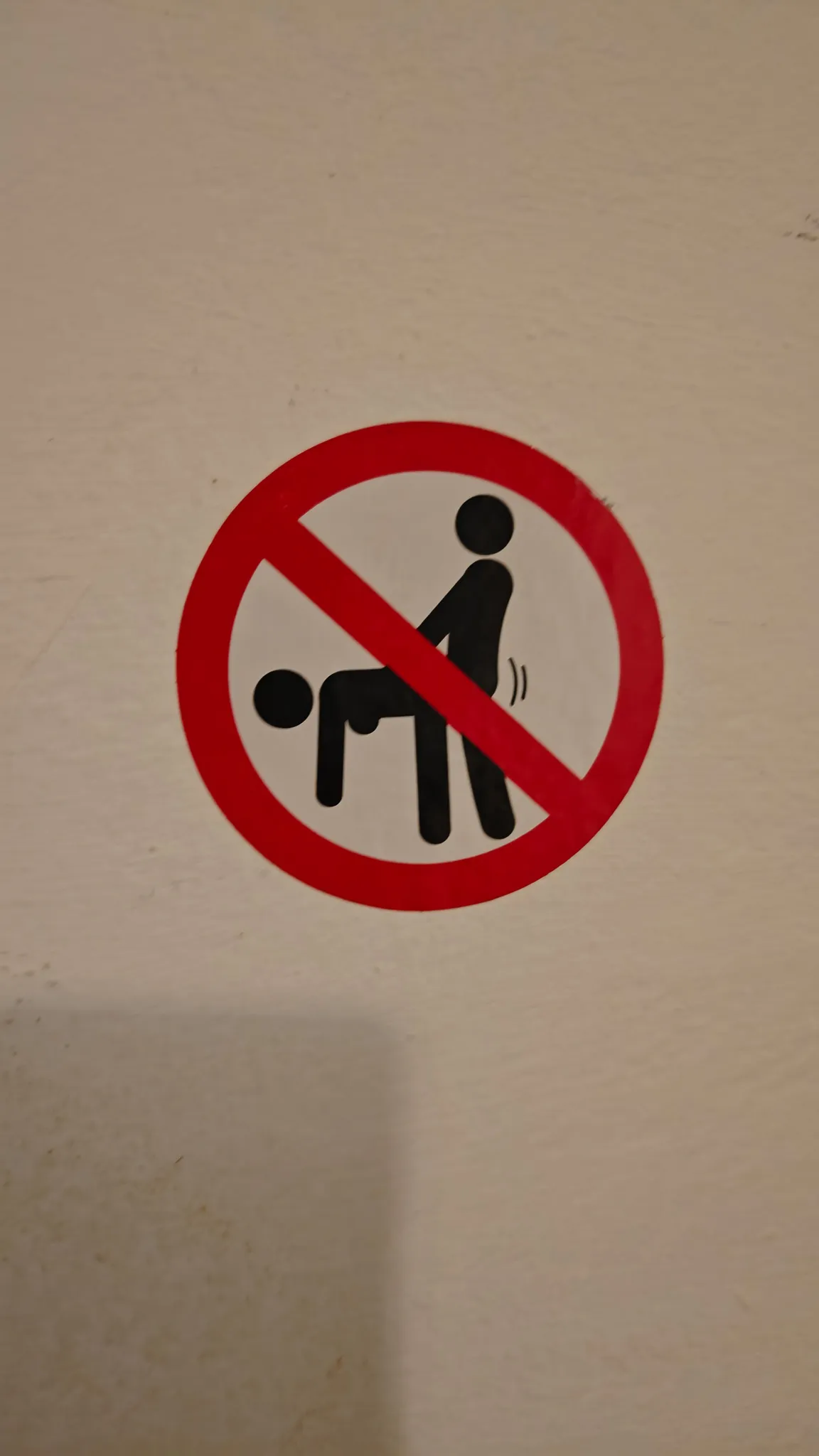 Another humorous prohibition sign sticker on a bar wall in Vang Vieng nightlife