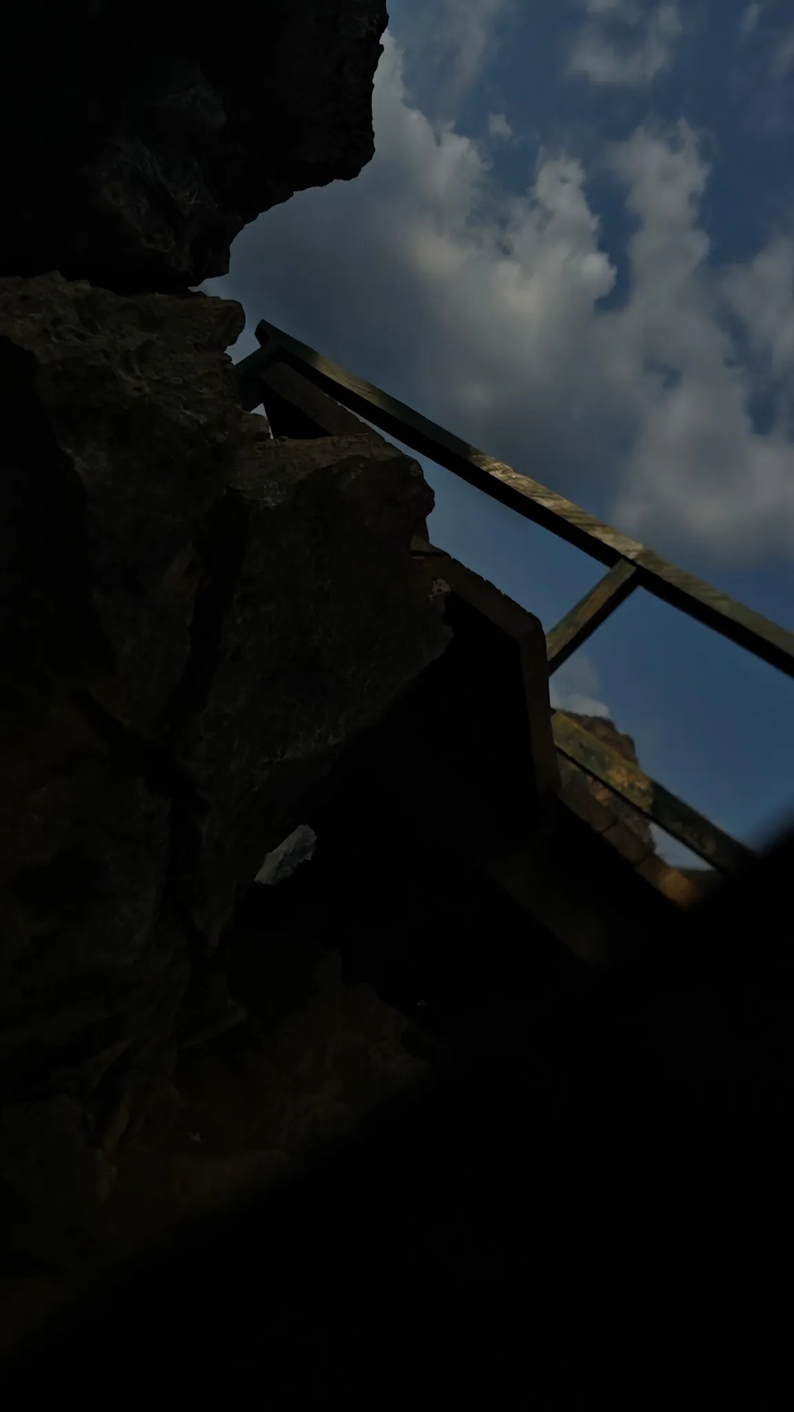 Hiking boots on the rocky limestone terrain at Nam Xay viewpoint in Vang Vieng