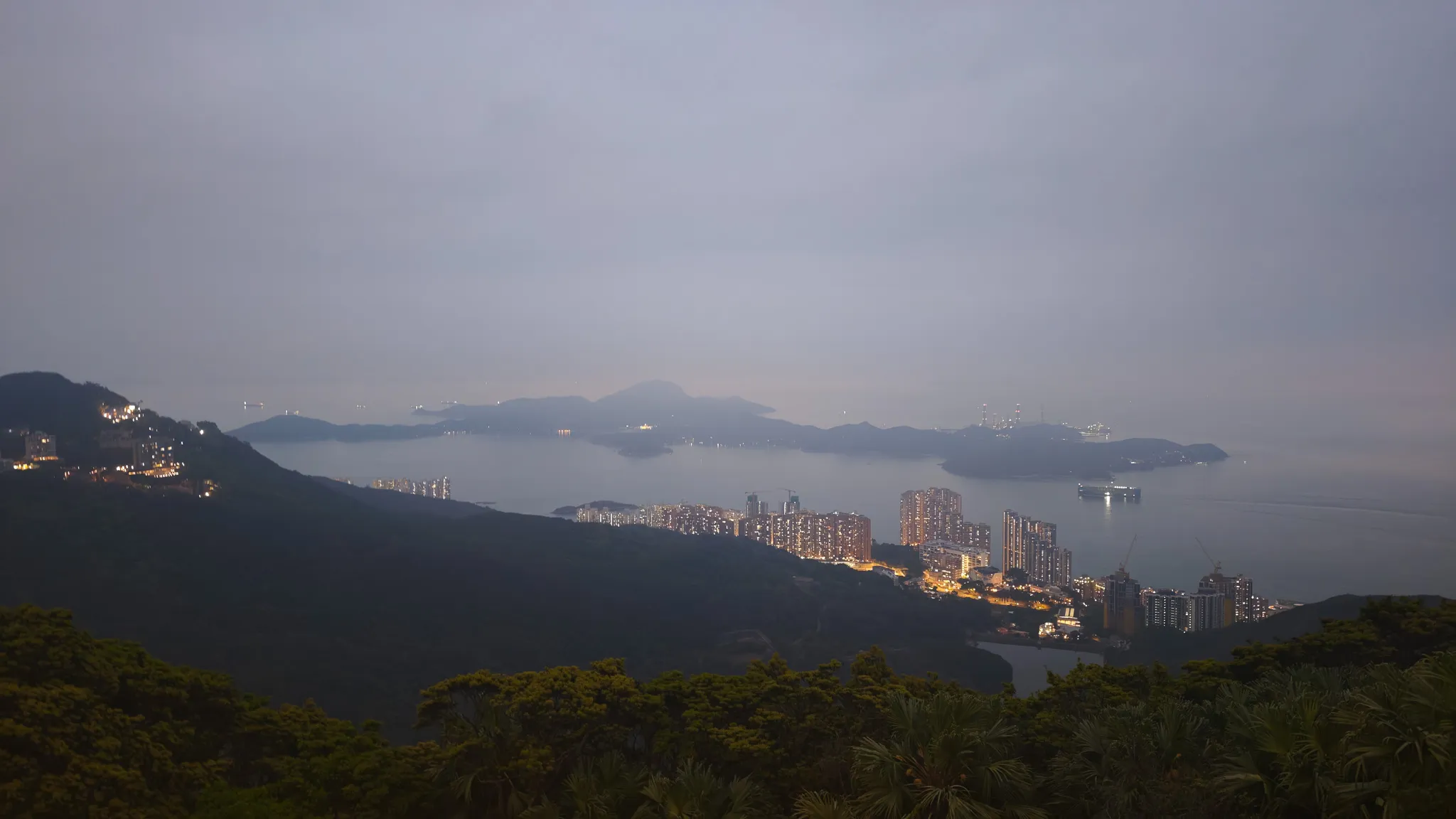 View from Victoria Peak at dusk looking south over Hong Kong island towards Lamma and outlying islands