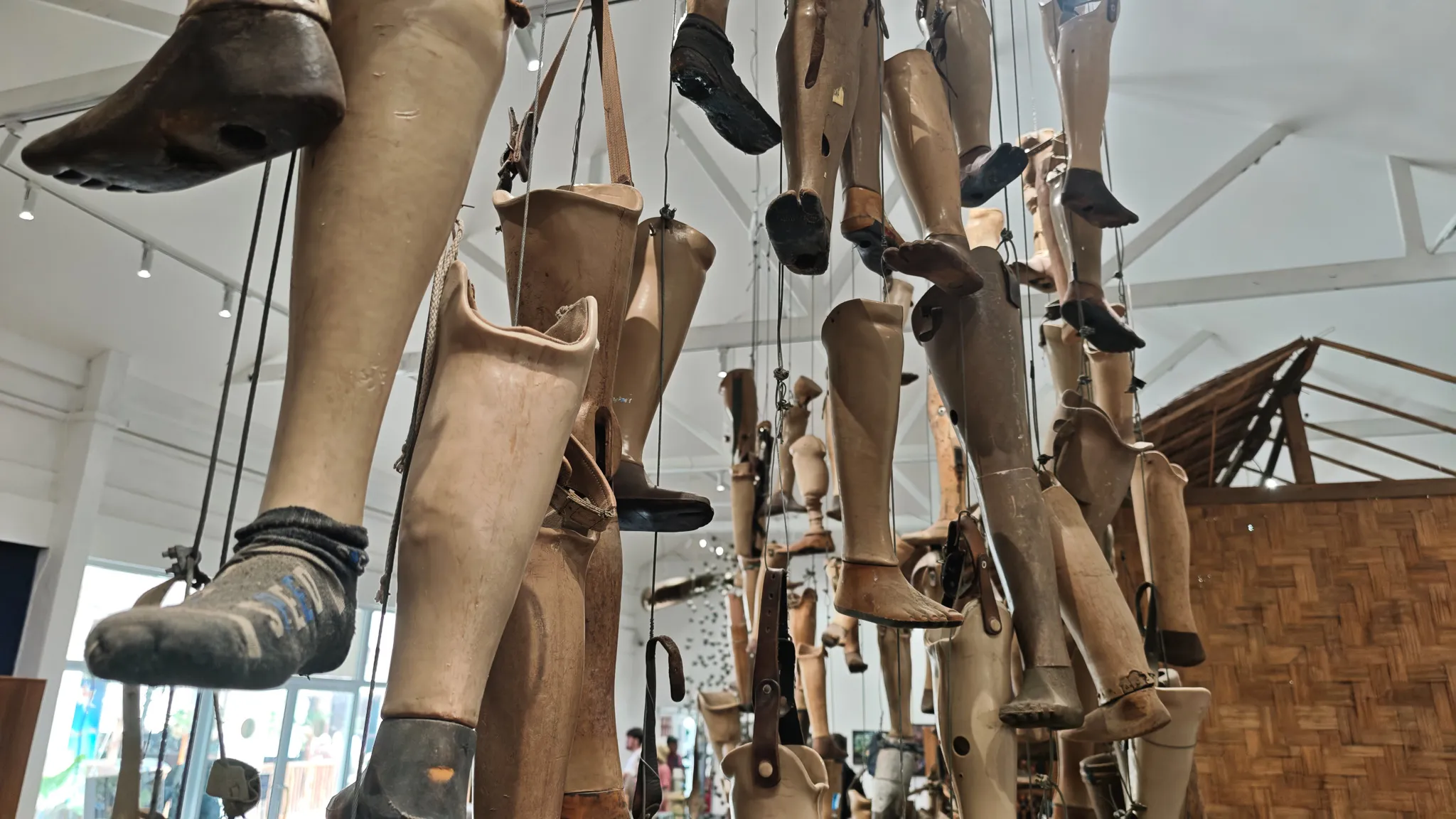 Dozens of prosthetic legs hanging from the ceiling at the COPE Centre in Vientiane highlighting UXO casualties in Laos