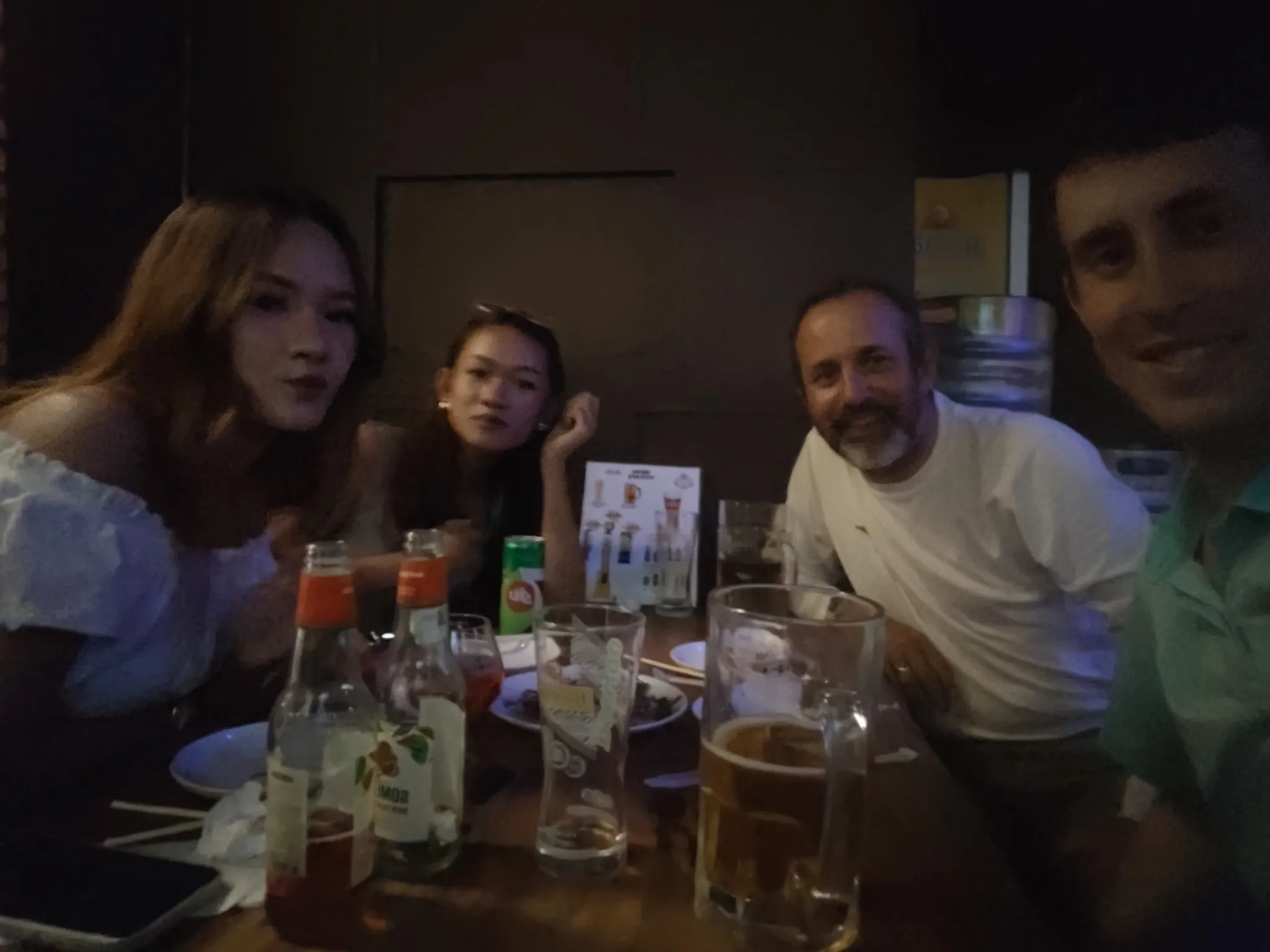 Dinner selfie with friends Jenny and Chompoo over beers and Lao food at a restaurant in Vientiane