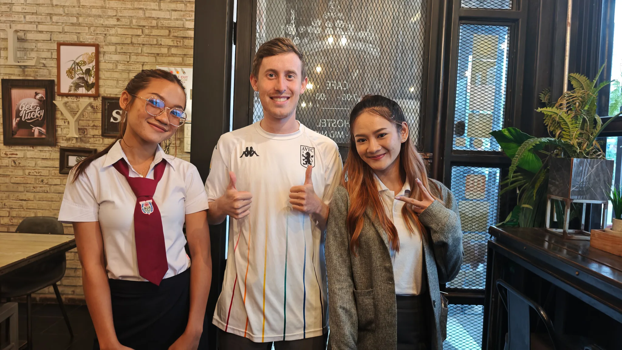 Smiling goodbye photo with two Lao women friends at a cafe in Vientiane before departing Laos