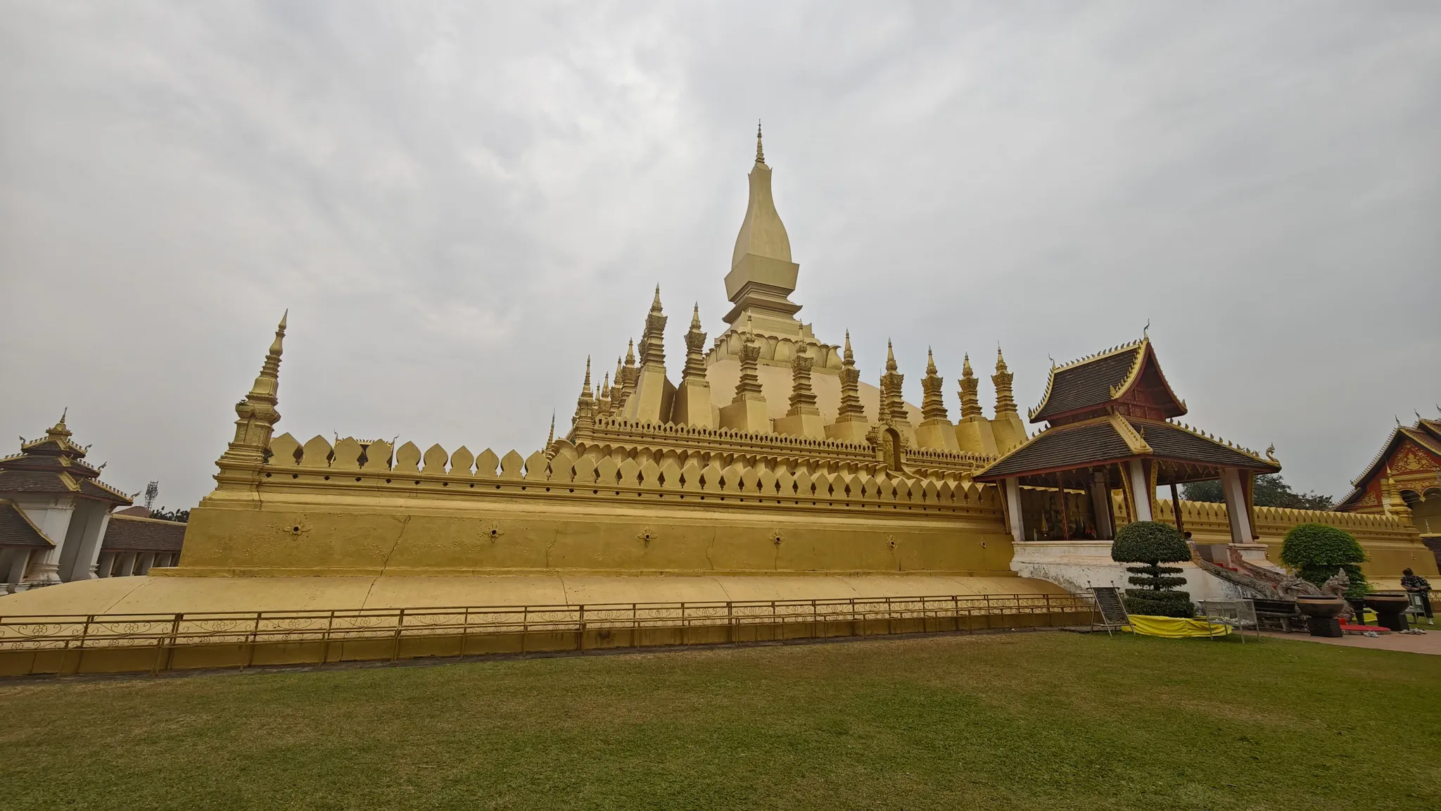 Pha That Luang, the golden stupa national symbol of Laos, with ornate spires and green lawns in Vientiane