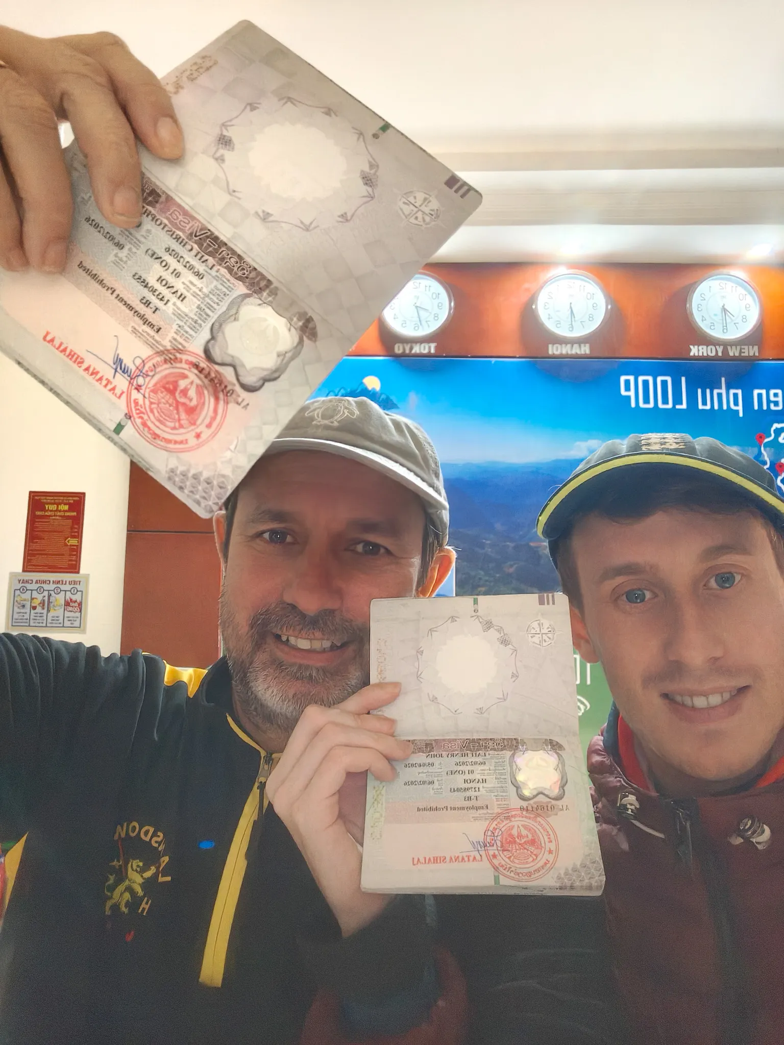 Two travellers showing their Vietnam visa stamps at a hotel in Dien Bien Phu before departing for Muang Khua