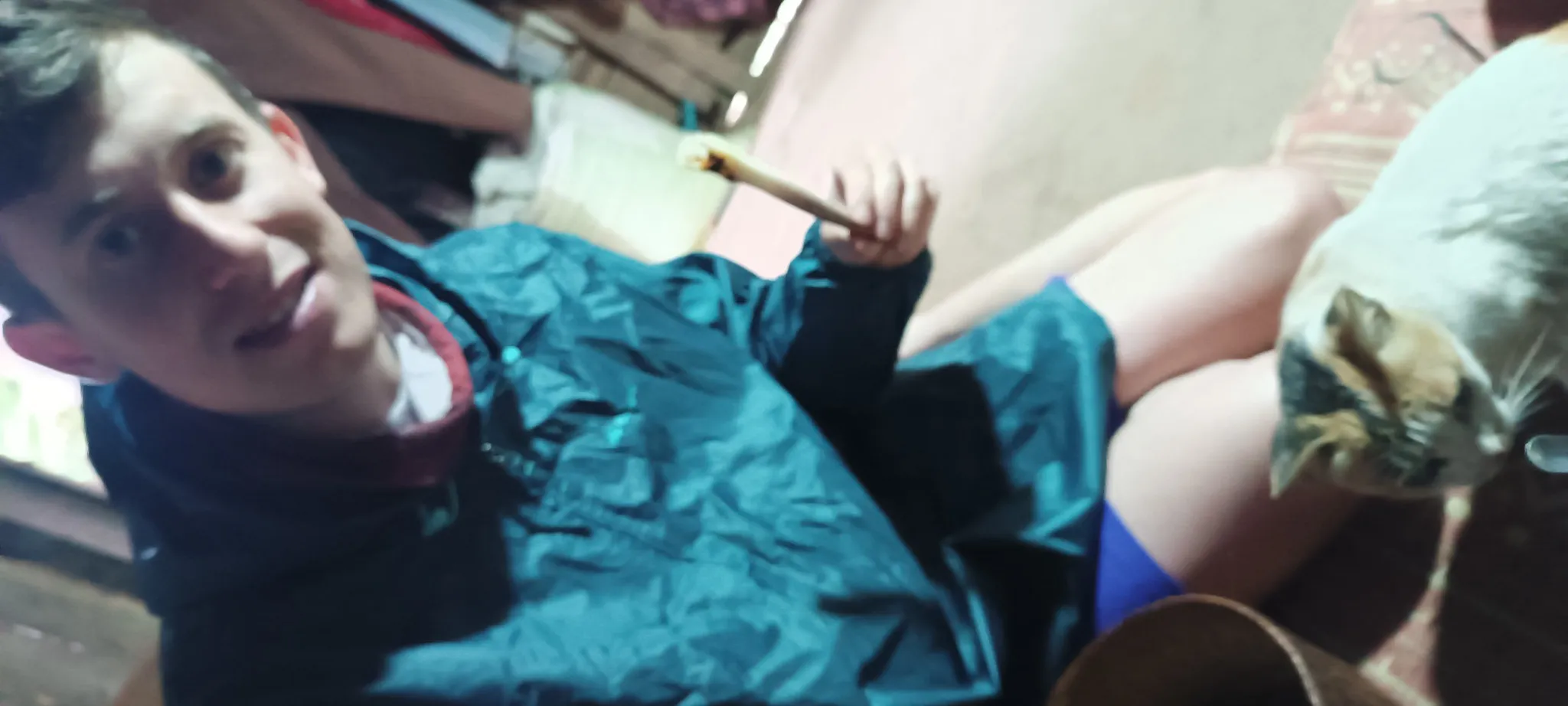 Traveller waking up inside a village hut during a packrafting trip along the Nam Ou river in Laos